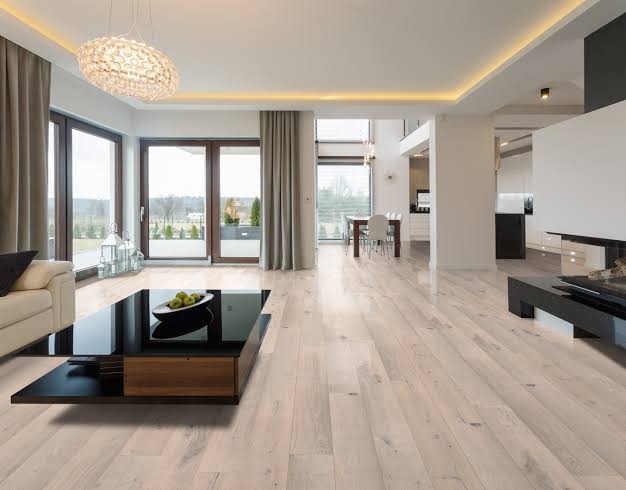 Pale timber-look flooring through an open-plan living and dining area